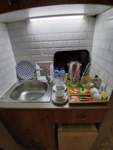 a kitchen counter with a sink next to a sink at Mayata Gallery in Istanbul