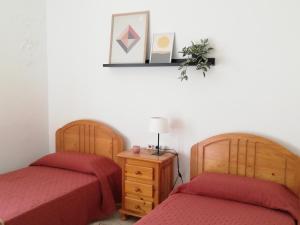 two beds sitting next to each other in a room at Casa La Parra in Tejeda