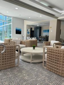 a waiting room with wicker chairs and a table at Eternal Sunrise Suite in Fort Lauderdale