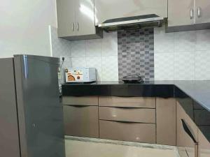 a kitchen with a stainless steel refrigerator and cabinets at Modern & homely 3bhk city centre in Jaipur +18 photos