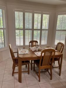 a dining room with a wooden table and chairs at Grandma’s White House in Palm Coast