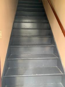 a flight of grey stairs in a room at Cozy 2nd Floor Apartment With Private Entrance in Chicopee