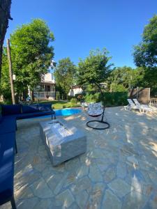 a stone patio with a bench and a pool at Dunavska lepotica 2 in Belgrade