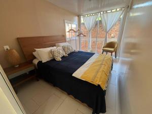 a bedroom with a large bed with a window at Casa Lorinda in Lo de Marcos