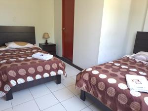 Postel nebo postele na pokoji v ubytování Hotel Residencial C´BASTIAN