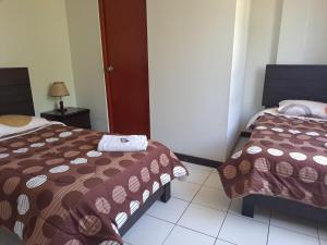 Postel nebo postele na pokoji v ubytování Hotel Residencial C´BASTIAN