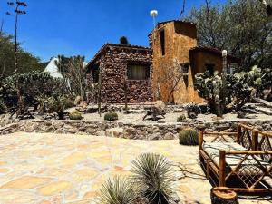 a stone patio in front of a house at Cabaña Coyote in Bernal