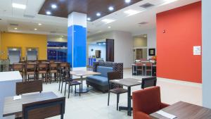 jadalnia ze stołami i krzesłami w restauracji w obiekcie Holiday Inn Express Manzanillo, an IHG Hotel w mieście Manzanillo