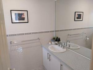 a bathroom with a sink and a mirror at beach house in Venus Bay +10 photos