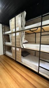 a group of bunk beds in a room at Hostel Hug Brasil in Curitiba