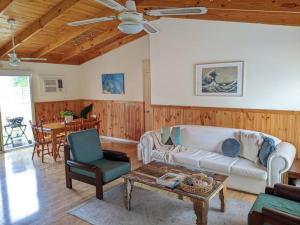 a living room with a couch and a table at beach house in Venus Bay