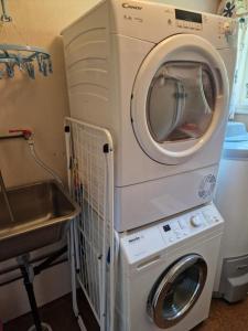 uma máquina de lavar e secar roupa num quarto com um lavatório em Idyllisk feriested em Røyksund