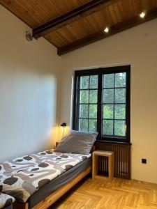 a bedroom with a bed and a large window at Willa no.18 in Reda