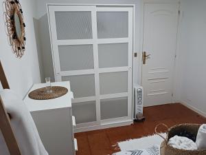 a white door in a room with a white counter at O Recuncho 17 in Fisterra +21 photos