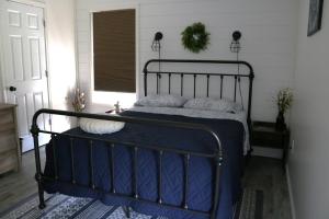 a bedroom with a bed with blue sheets and pillows at Country Hills Hideaway in Millersburg