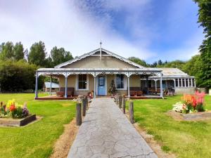 Peter's Farm Lodge في Waipiata: منزل أمامه مسار