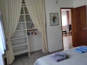 a bedroom with a bed and a book shelf at Beautiful holiday location in Solís in Balneario Solís