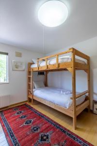 a bedroom with two bunk beds and a rug at Chalet Murasaki in Niseko