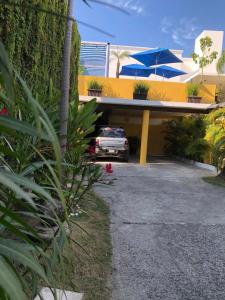 a car parked in the driveway of a house at Hotel Boutique Ixaya in Puerto Vallarta