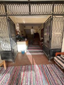 a living room with a staircase and a rug at Dahab Vibes Hotel in Dahab