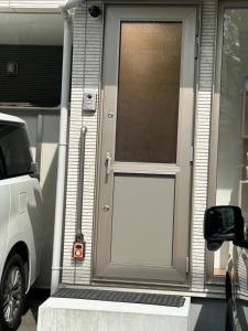 a white garage door on a house with a car at ハーモニー地下鉄幌平橋駅徒歩6分市電行啓通駅2分 in Sapporo +3 photos