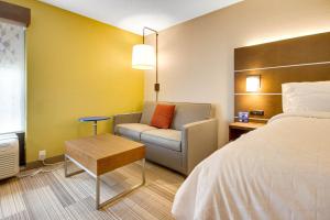 a hotel room with a bed and a chair at Holiday Inn Express Dublin by IHG in Dublin +27 photos