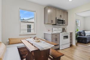 a living room with a table and a kitchen at Covered Patio With Grill Affordable Comfy Stay in Rapid City