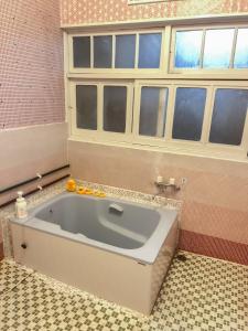 a bath tub in a bathroom with a window at Mojiko Guesthouse PORTO in Kitakyushu +31 photos