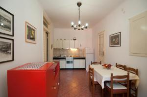 a kitchen and dining room with a table and a red refrigerator at Apartment Villa Minach in Volosko