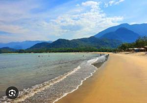 a beach with a ball in the water at Casa Ártemis Paraty in Sertão do Taquari +8 photos