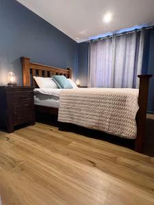 Ένα ή περισσότερα κρεβάτια σε δωμάτιο στο Morisset Cottage Blackheath