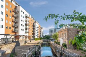 a river in a city with buildings at Penthouse w/ Hot Tub near Stratford, Westfield in London