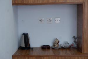 a shelf with a coffee maker on top of it at Pondok Alengkong in Bangli
