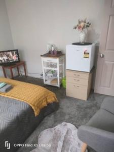 a bedroom with a bed and a dresser and a chair at Cozy Double Room - WIFI in Hamilton