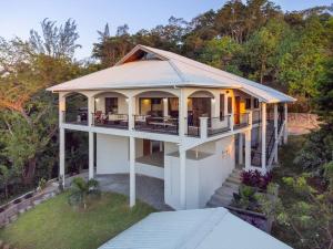 an aerial view of a house with a porch at Apricari Villa / Luxury Views / 5 BDRM / Pool in Roatan