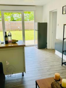 a kitchen with a counter and a refrigerator at Maison avec accès au lac in Izon