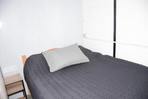 a bedroom with a bed with a pillow on it at Mi linda casa de campo in Nocaima