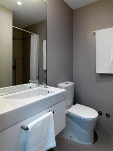 a bathroom with a sink and a toilet and a mirror at Uporto House Villa in Porto +23 photos