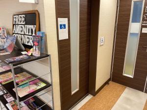a room with a door and a shelf with books at Kyoto Central Inn in Kyoto