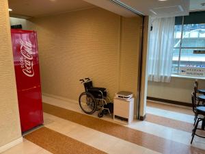 a wheelchair in a hallway with a coca cola sign at Kyoto Central Inn in Kyoto