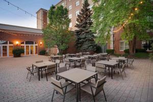 a courtyard with tables and chairs in front of a building at Chicago Marriott Midway in Bedford Park
