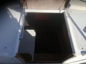 an open back door of a boat with the door open at Sleep in the bay on my boat in Porto San Paolo