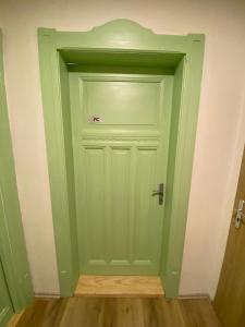 a green door in the corner of a room at MINATO Apartments Ostrava center in Ostrava