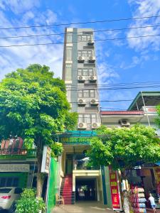 un grand bâtiment avec un magasin devant lui dans l'établissement Tam Giác Mạch Hotel, à Ha Giang