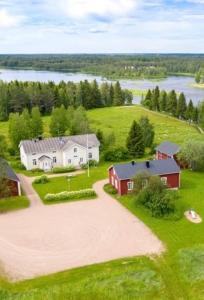 an aerial view of a farm with a house and a driveway at Liepeen pappila in Pudasjärvi