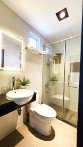 a bathroom with a toilet and a sink and a shower at Rosa May Hotel in Ho Chi Minh City
