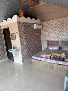 a bedroom with a bed and a sink in a room at Dream Bedouin life camp in Wadi Rum