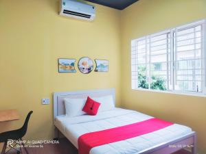 a bedroom with a bed with a red pillow and a window at Shusimi Boutique Villa SG Near Tan Son Nhat Airport in Ho Chi Minh City