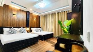 Giường trong phòng chung tại Rosa May Hotel