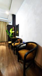 a waiting room with yellow chairs and a table at Rosa May Hotel in Ho Chi Minh City